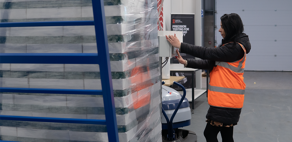 Specialist checking acceleration controls in a load stability Test Centre