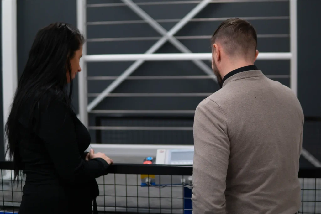 Kamila and Jay looking at machine settings on the vibration tilt bench