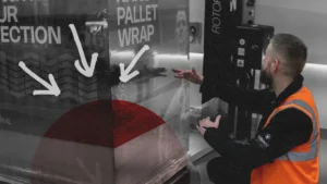 Load Stability Technician assessing the load containment of a pallet on a turntable wrapper