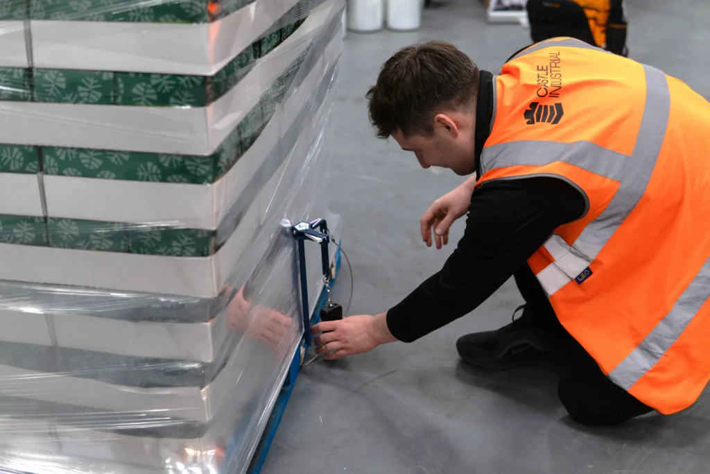 Technical Consultant using CFT-6 device to measure load containment force on a wrapped pallet