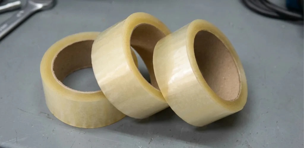 Three rolls of industrial tape on a warehouse bench